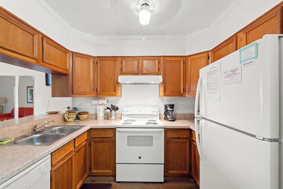 Your fully equipped kitchen features warm wood cabinets, full-size appliances, and everything you need to prepare delicious meals during your stay.