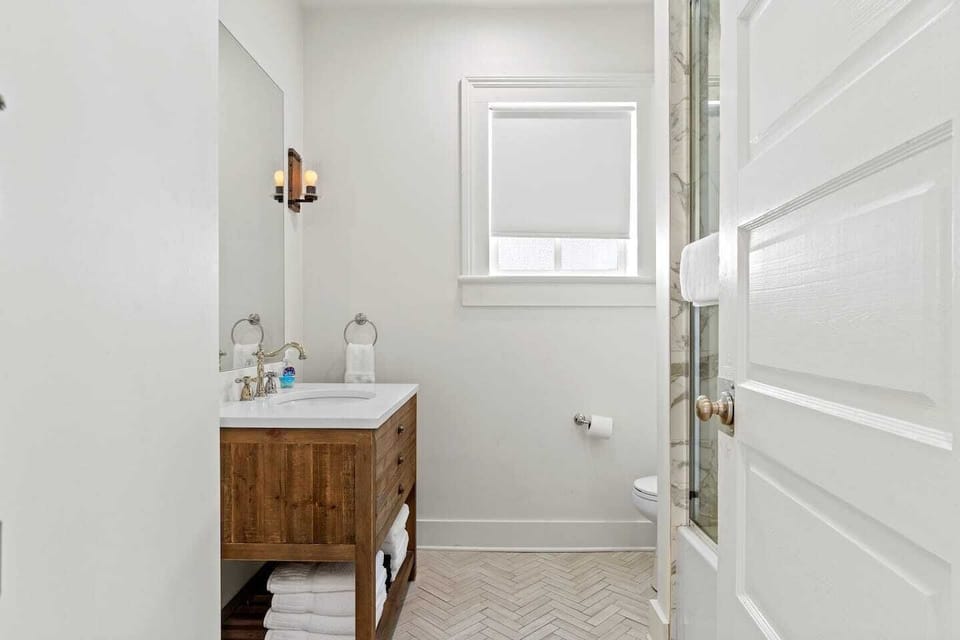 First bathroom w/ a spacious shower & large mirror.
