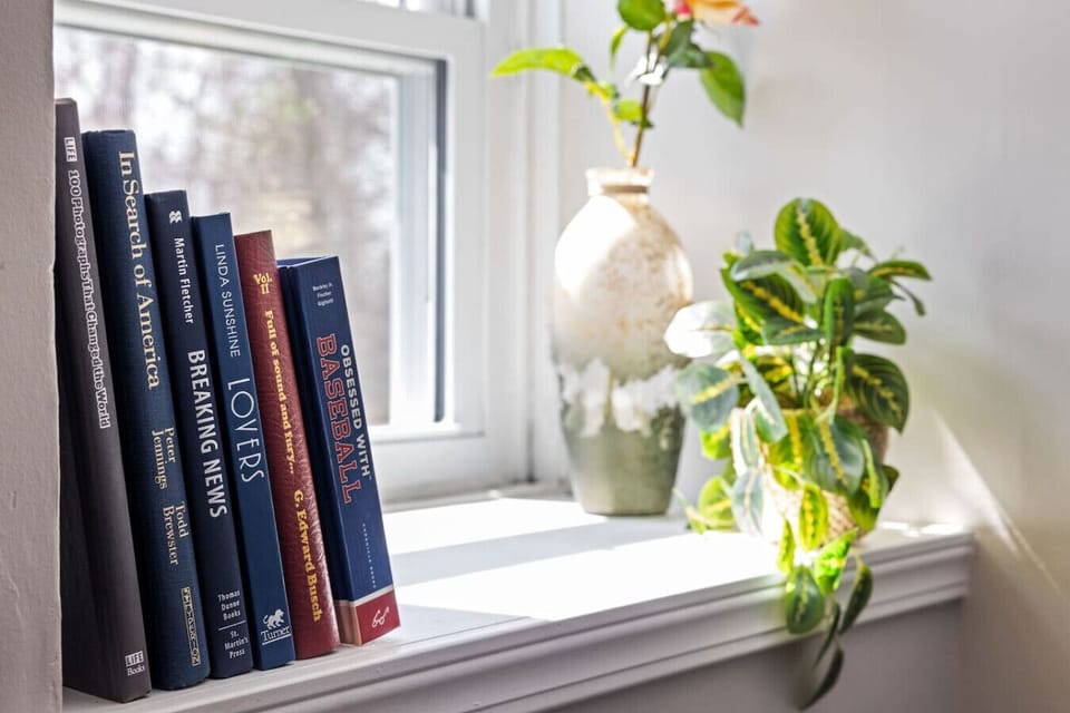 Cozy Corner with a View – Let the natural light and leafy outlook make this the perfect pause in your day.