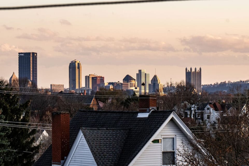 A view of downtown (6 minutes away!) from the window seat in this 3rd floor bedroom, while everything stays peaceful in our quiet neighborhood.