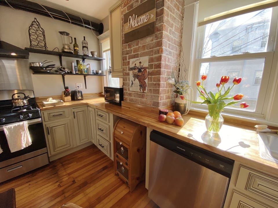 Warm 1st floor kitchen. New cabinets + counters w/original heart pine floors 🤩