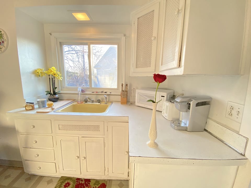 Bright, sunny upstairs kitchen fully stocked for your cooking needs. 