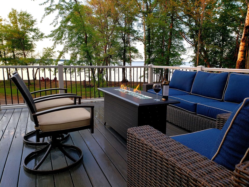 Upper deck seating and gas firepit. Upstairs bedroom opens to upper deck. 