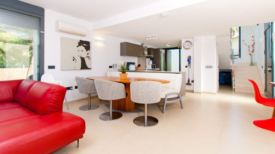 Here you can see the large living area. There are many different things here, such as a cozy modern dining table or a huge kitchen.