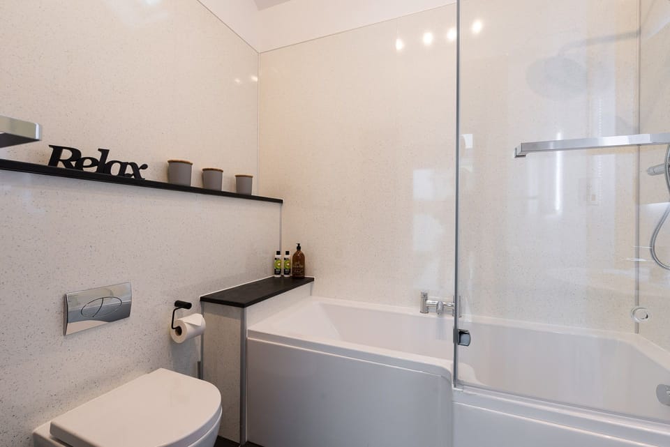 Family bathroom with bath and shower overhead