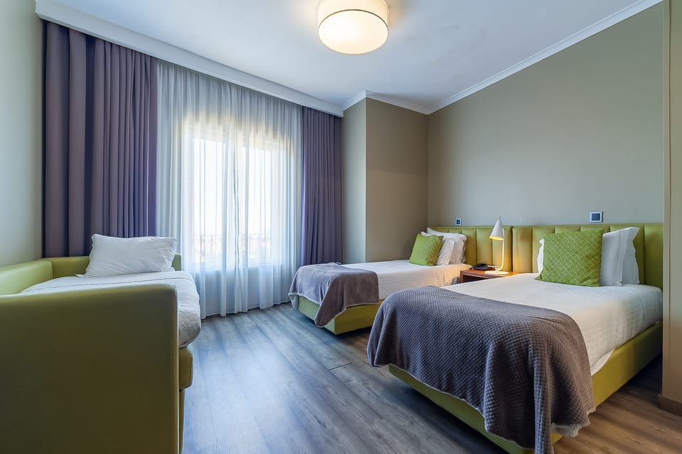 Standard Triple Room | Minibar, in-room safe, desk, blackout drapes