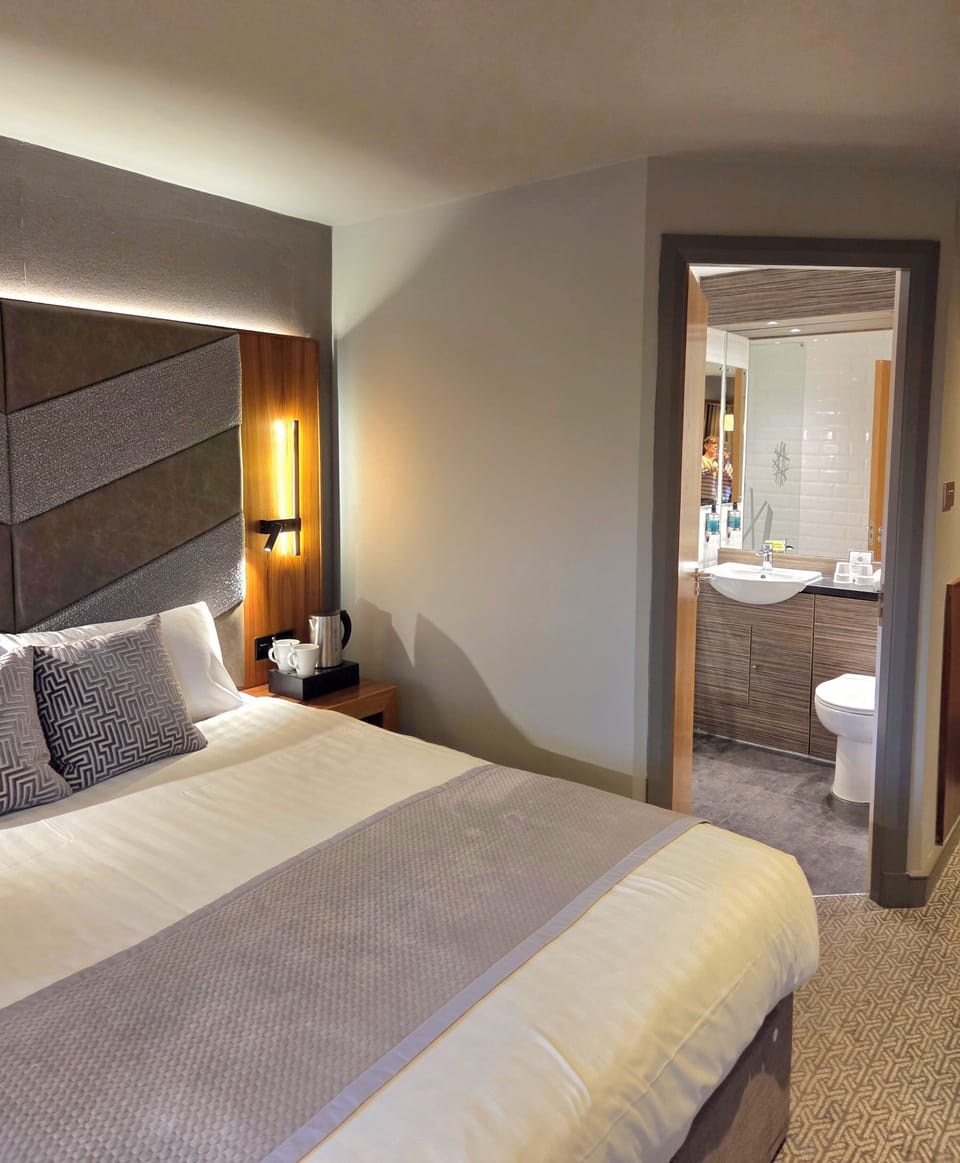 Comfort King | Desk, laptop workspace, blackout drapes, iron/ironing board