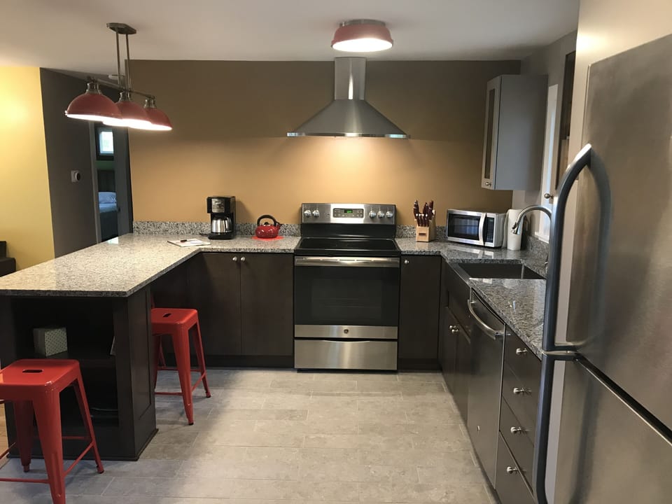 New modern eat-in kitchen with all stainless appliances and granite countertops 