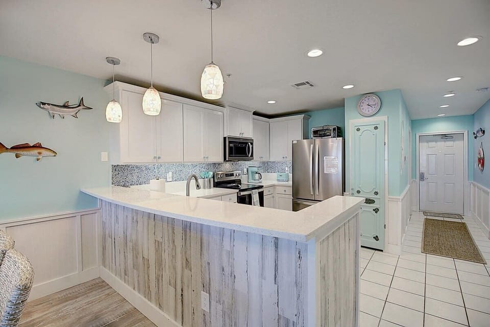 Kitchen — White Cabinets, Mosaic Backsplash, Quartz Counter, Fish Wall Art & Entry View
