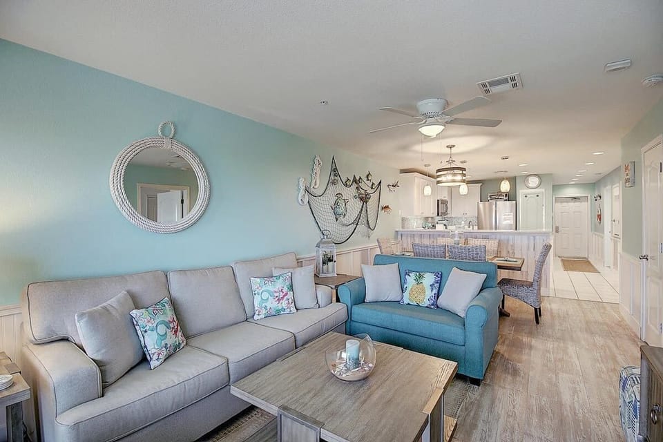 Living & Dining — Gray Sofa, Teal Loveseat, Rope Mirror, Fishing Net & Seahorse Decor