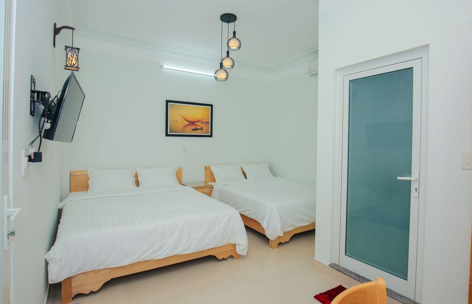 Standard Quadruple Room, City View | Minibar, individually decorated, individually furnished, desk