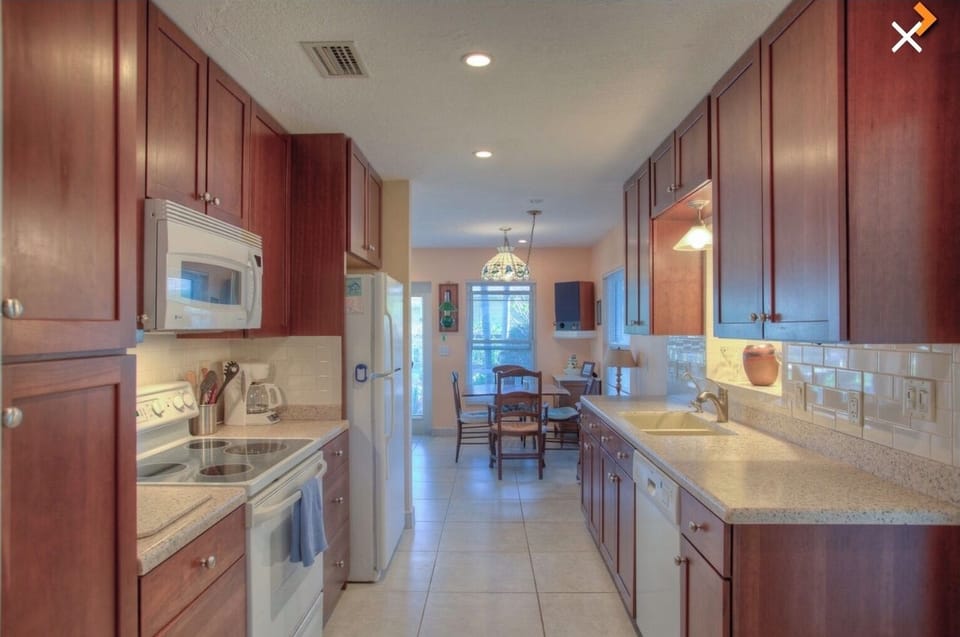 Quartz countertops; cherry cabinets. Ample work space. 