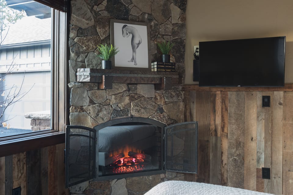 Bedroom 5 - fireplace and television.