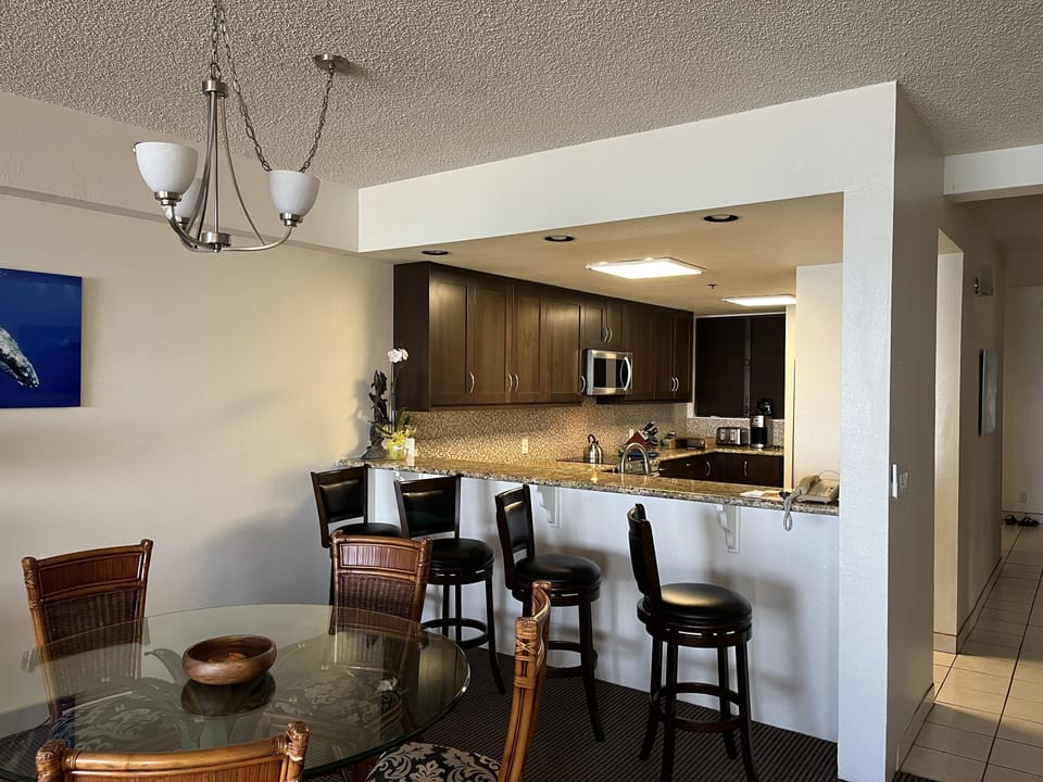 Large dining room area with table for six plus four more at the counter top!
