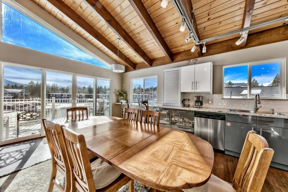 Your open dining space features rustic wood beams, panoramic windows, and mountain views that create the perfect backdrop for memorable meals together.