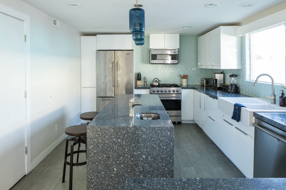 The sleek kitchen features an island and state-of-the-art appliances.