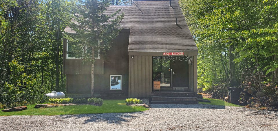 Exterior view of the front entrance and gravel driveway.