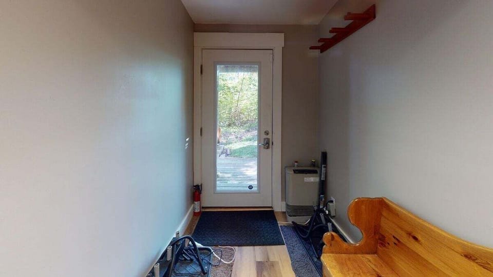 Back entry hallway with a small bench and space for shoes and gear.