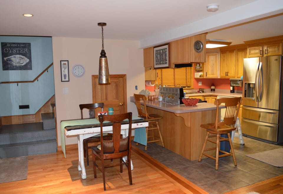Small table inside and a kitchen that has everything that you need.