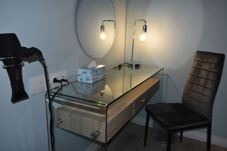 Premium bedding, desk, laptop workspace, blackout drapes