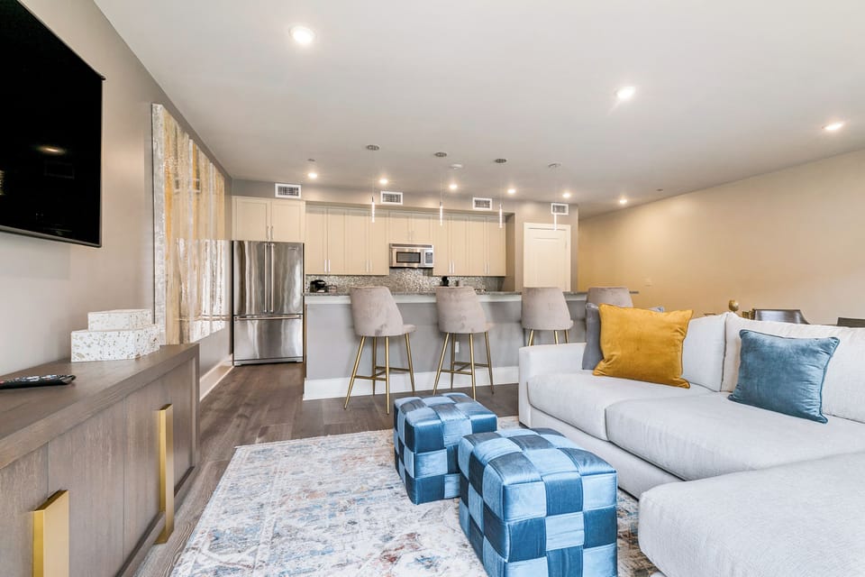 Open-concept living, kitchen, and dining area with plenty of seating. Enjoy a 65” Samsung Smart 4K TV with streaming and DIRECTV Entertainment. Dining table for six and bar seating for four. Lots of natural light too!