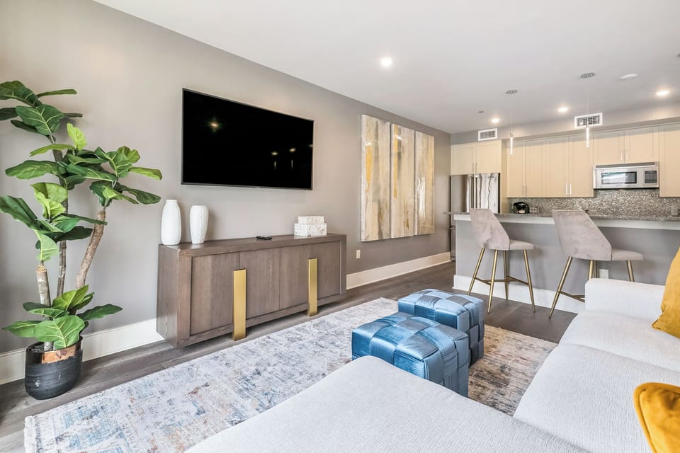 Open-concept living, kitchen, and dining area with plenty of seating. Enjoy a 65” Samsung Smart 4K TV with streaming and DIRECTV Entertainment. Dining table for six and bar seating for four. Lots of natural light too!