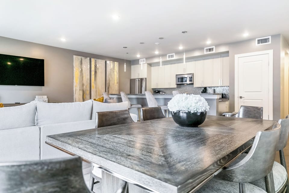 Open-concept living, kitchen, and dining area with plenty of seating. Enjoy a 65” Samsung Smart 4K TV with streaming and DIRECTV Entertainment. Dining table for six and bar seating for four. Lots of natural light too!