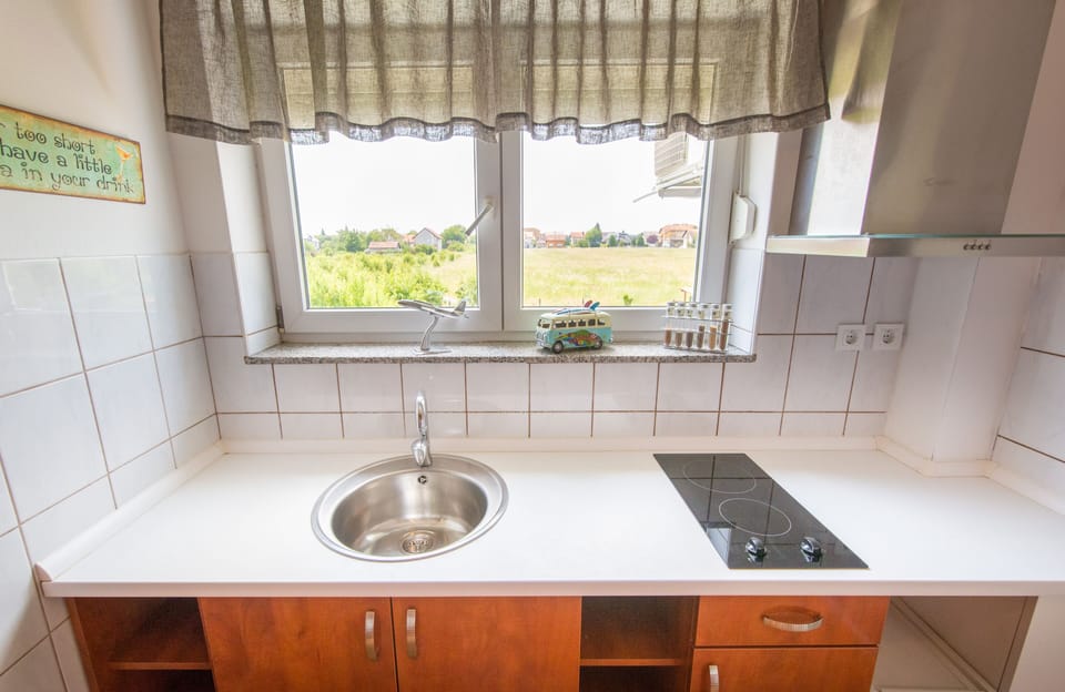 Family Apartment, Garden View | Private kitchen | Mini-fridge, electric kettle, highchair, cookware/dishes/utensils