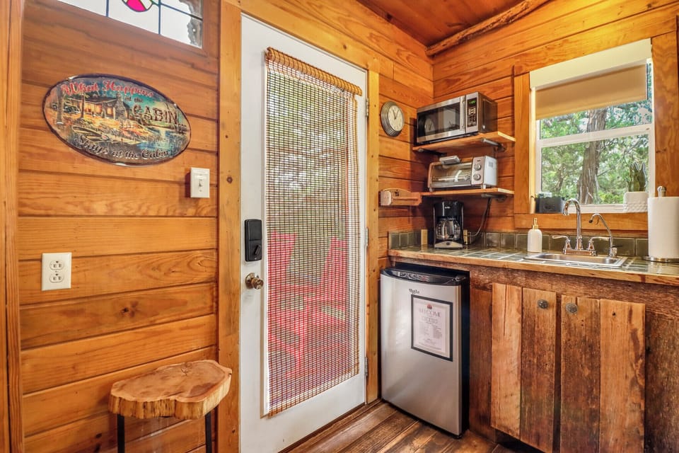 The kitchen features a mini fridge