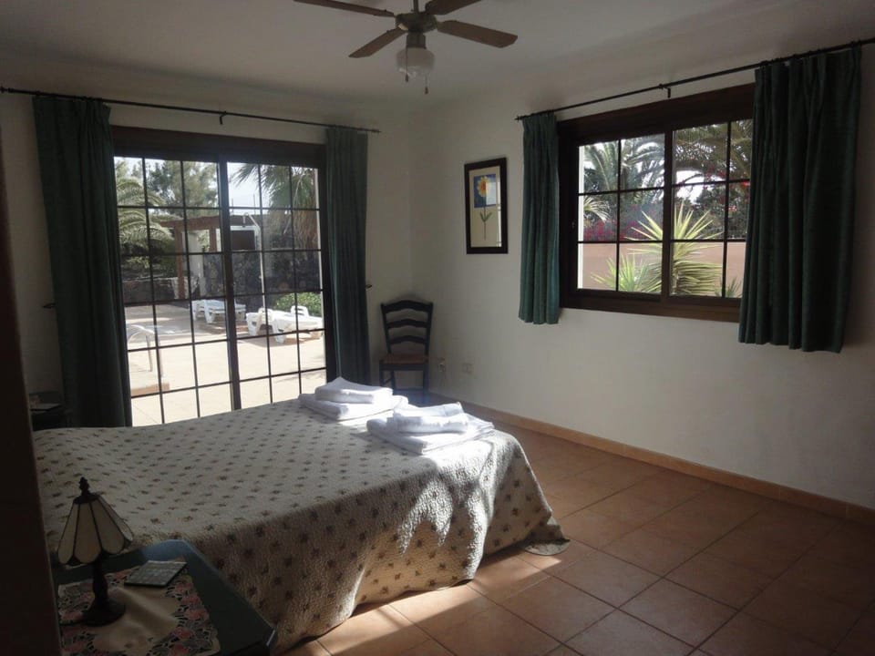 Main bedroom looks out to pool and gardens