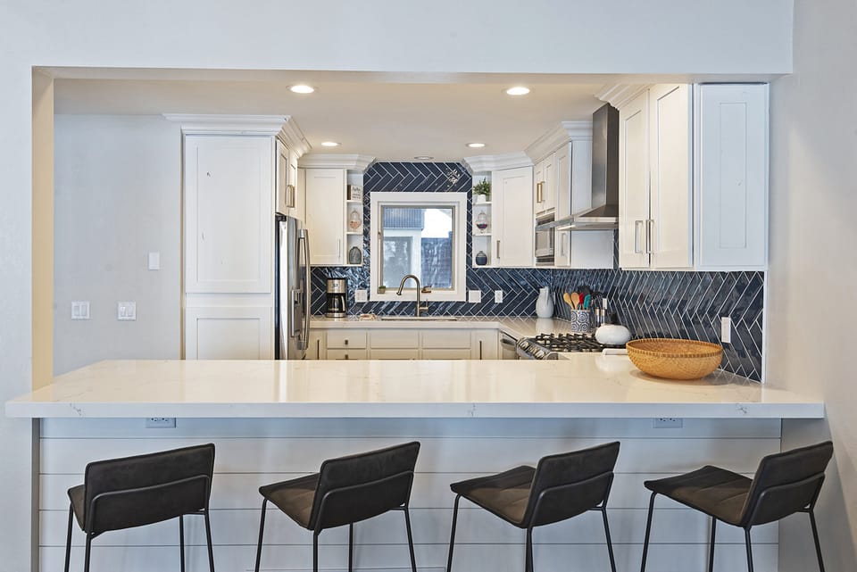 Fully Equipped Kitchen with Bar Seating for Four, Stone Countertops, and New Stainless Steel Appliances