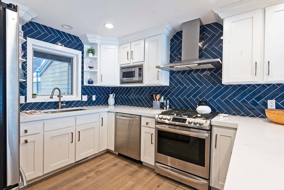 Fully Equipped Remodeled Kitchen with Stone Countertops and Stainless Steel Appliances Including a Gas Range