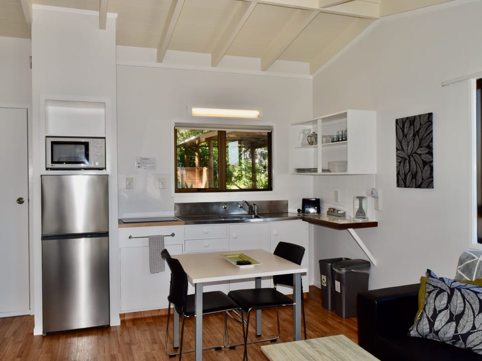 One Bedroom Unit | Private kitchenette | Microwave, highchair, cleaning supplies