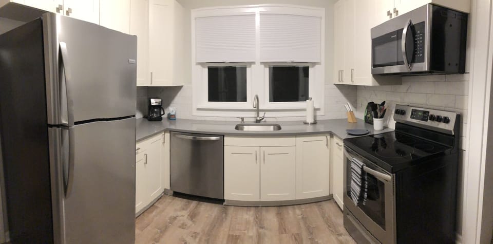 Panoramic view of fully-stocked kitchen