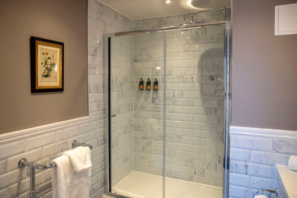 Shower, designer toiletries, hair dryer, bathrobes