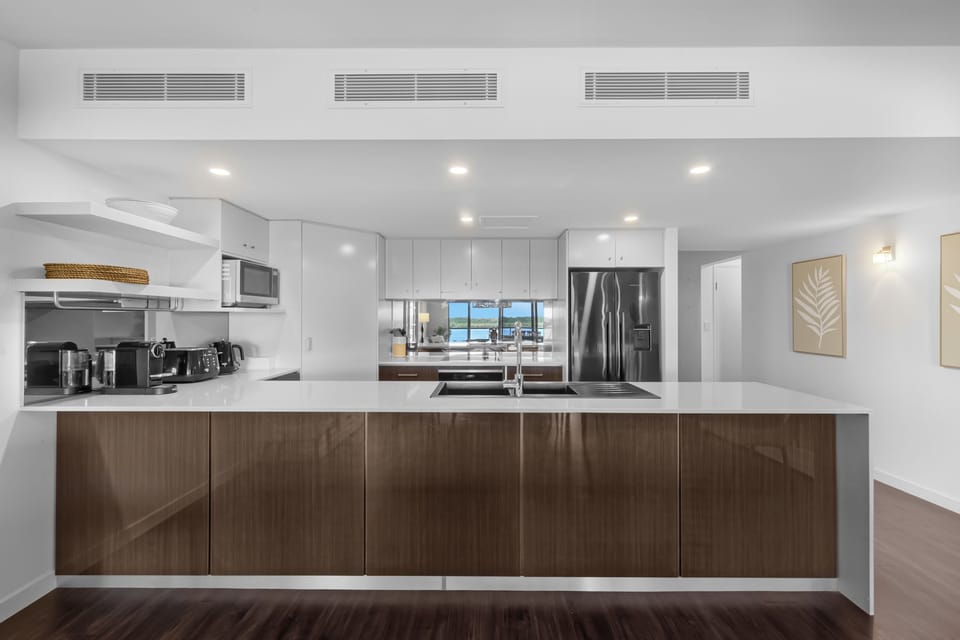 Deluxe Two Bedroom Apartment | Private kitchen | Coffee/tea maker, full-size fridge, microwave, oven