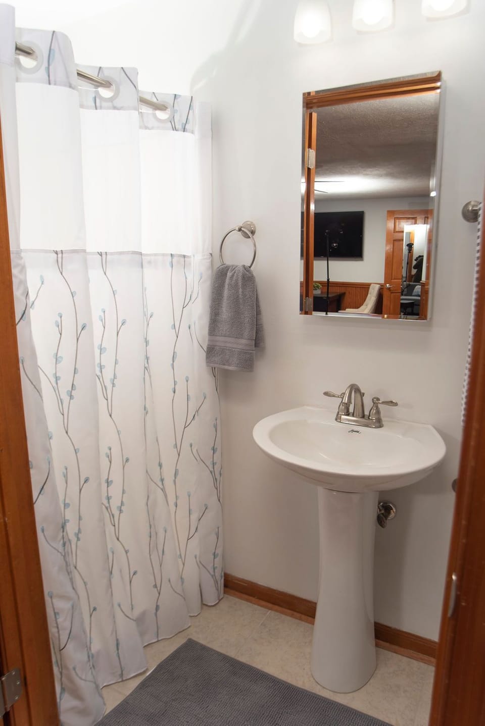 Full bathroom includes shower, pedestal sink, and toilet.