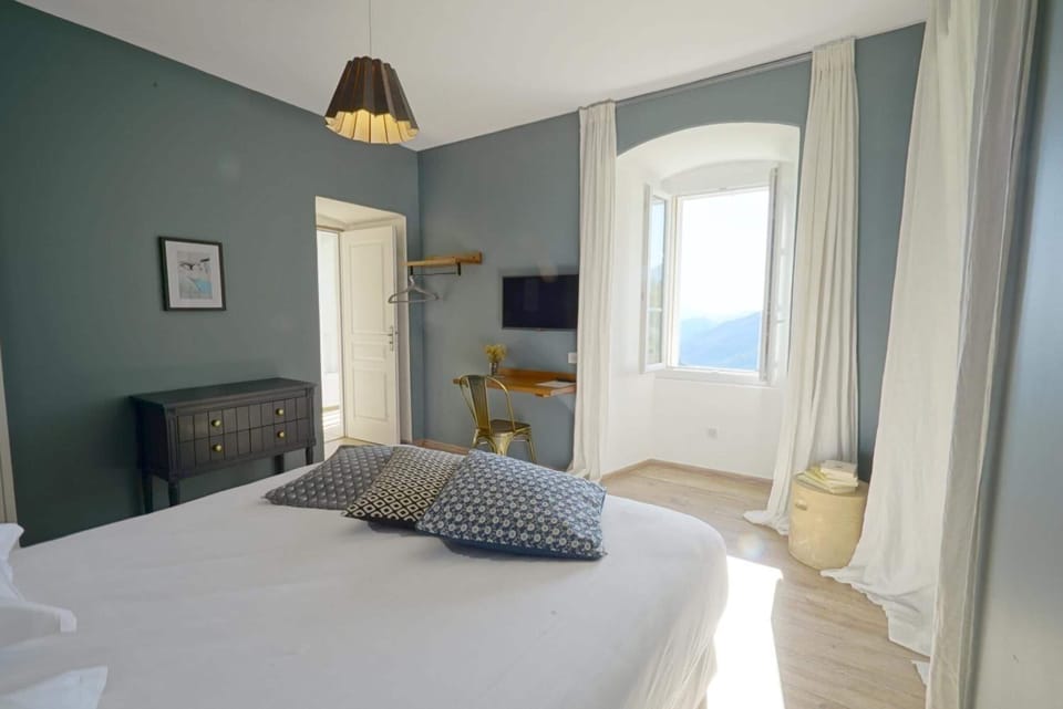 Premium bedding, desk, laptop workspace, blackout drapes