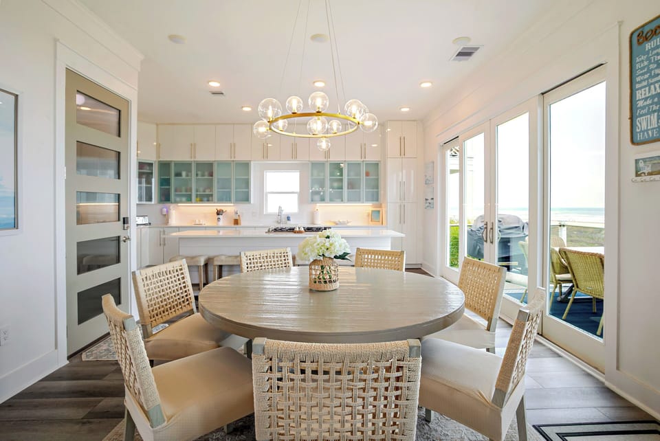 Open space with kitchen, dining table, outdoor table, and grill for the family