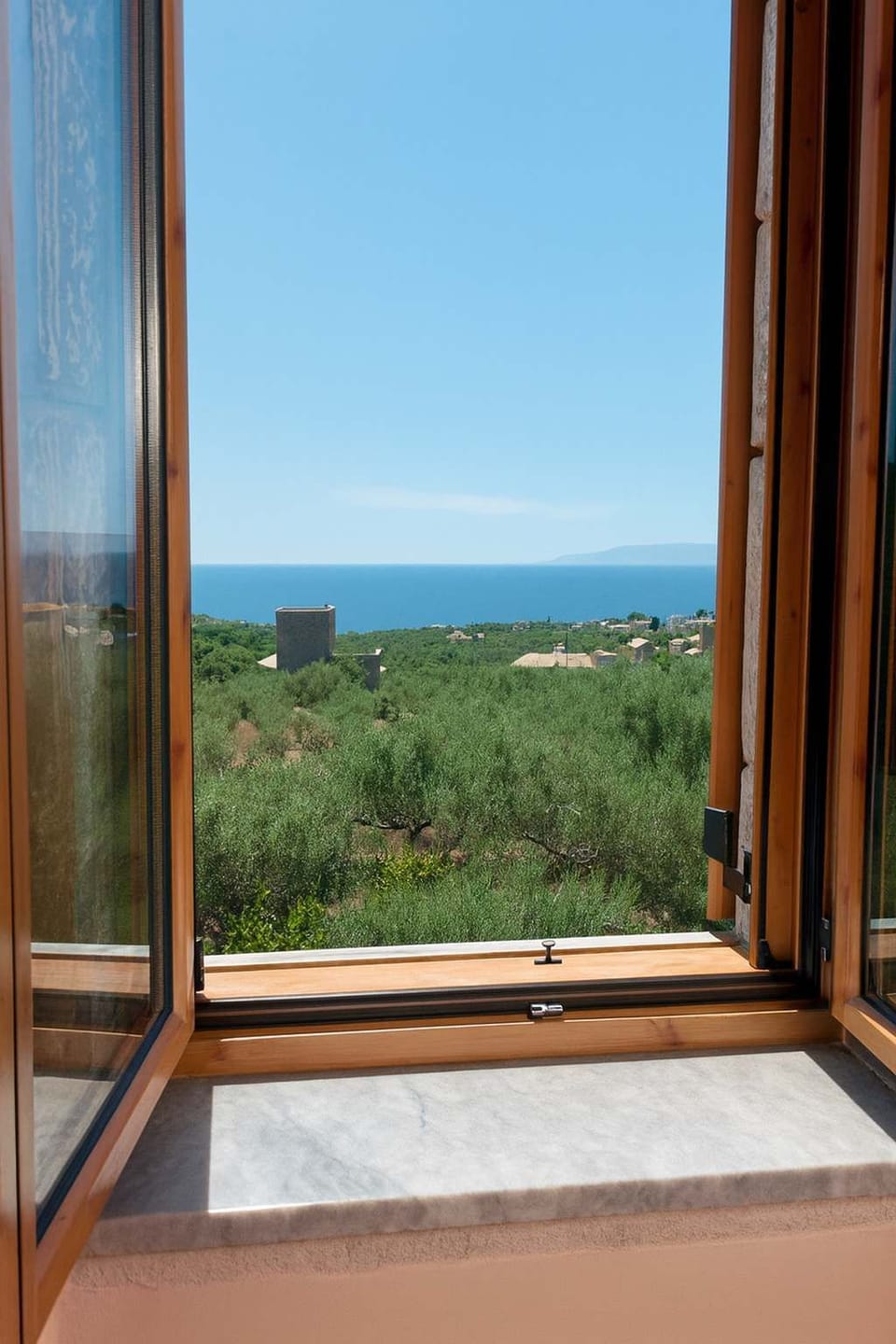 Scenic Window View from the Second-Floor Bedroom – Enjoy panoramic sea and countryside views directly from the window, bringing nature into your bedroom space.