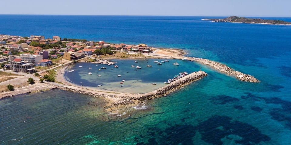 Explore the Charming Fishing Village of Marathoupoli with Seaside Taverns and Island Views
