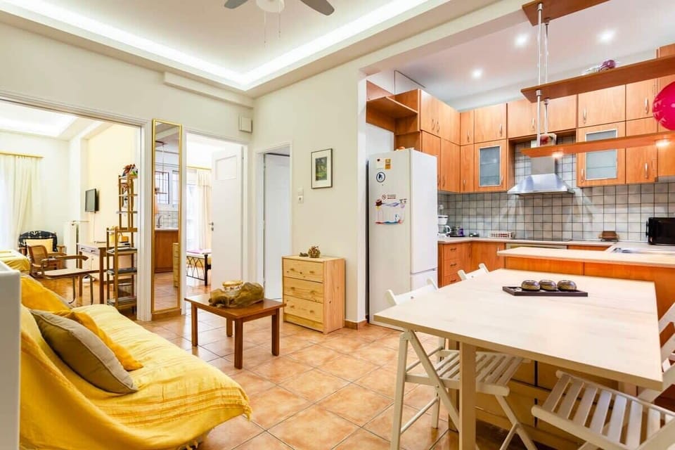 Open-Plan Kitchen and Dining Area
Shared space with red cabinetry, full-size fridge, oven, and open shelving — ideal for preparing meals and enjoying them at the adjoining dining table.
