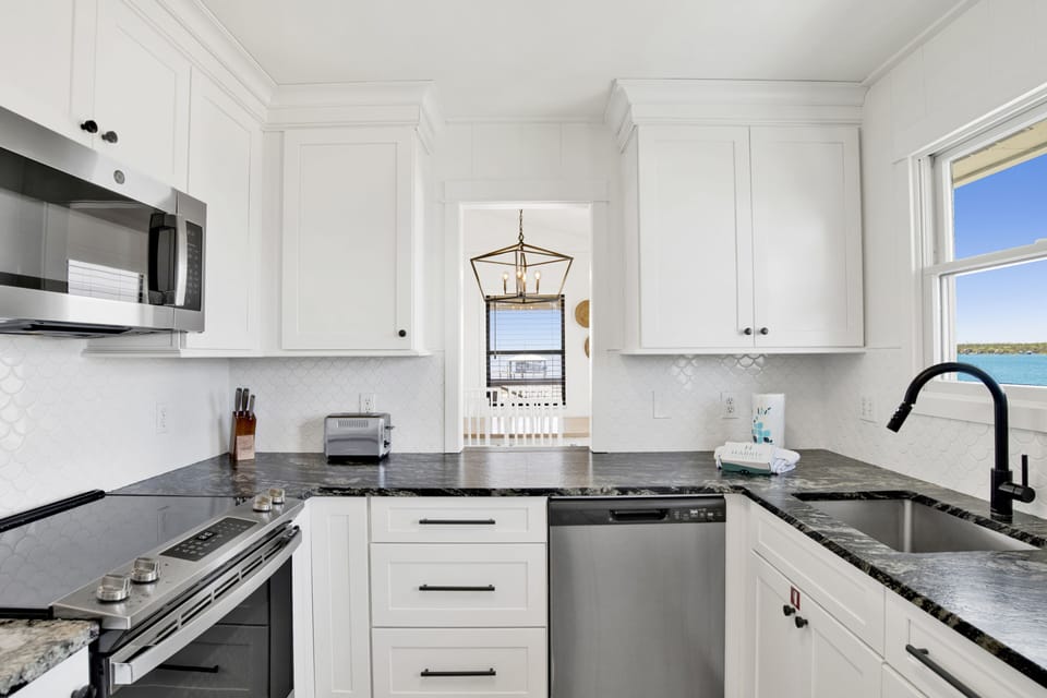 The updated kitchen is fully equipped with stainless appliances