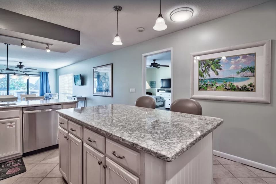 Kitchen with quartz countertops and more seating.
