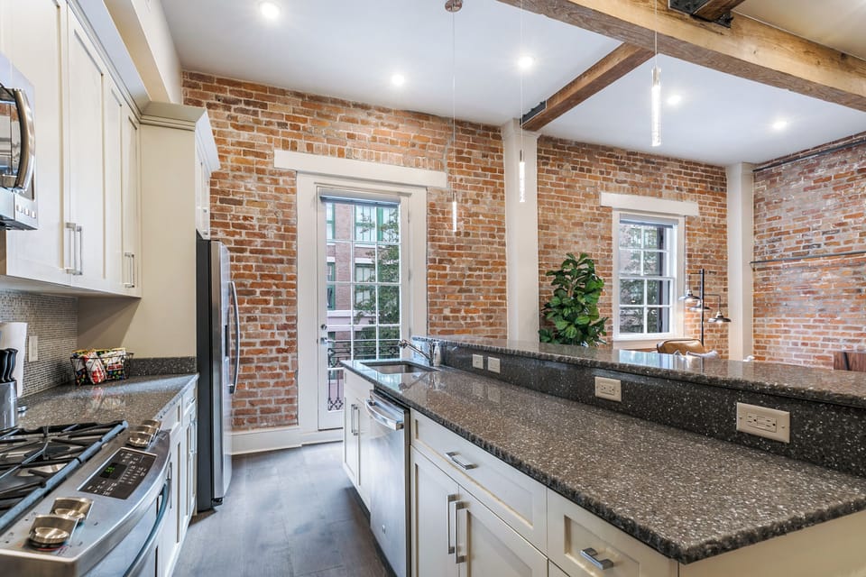 Cook and dine easily in the fully stocked kitchen, equipped with all stainless steel appliances, gas range, basic cookware, and a dining area for a comfortable meal at home. Entertain at the bar with seating for four.