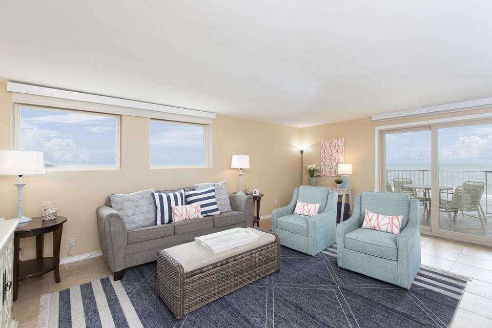 Living room with sleeper sofa and gorgeous ocean views from wall to wall!