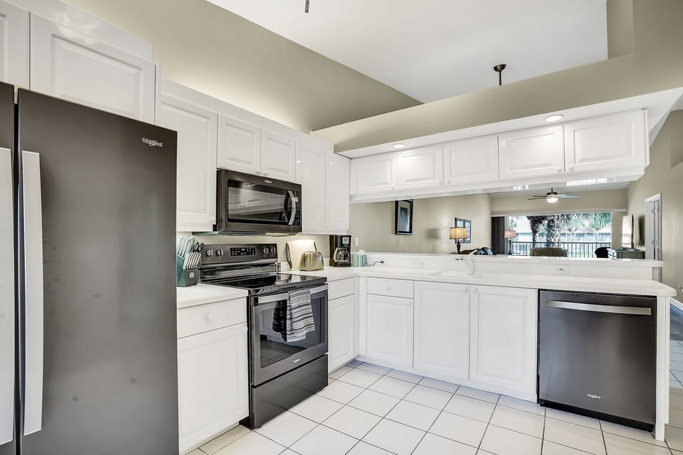 Fully equipped kitchen with newer Whirlpool appliances.