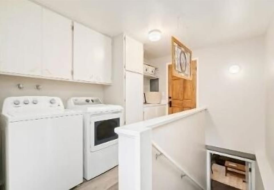 You enter into the laundry room, your unit is at the bottom of the stairs