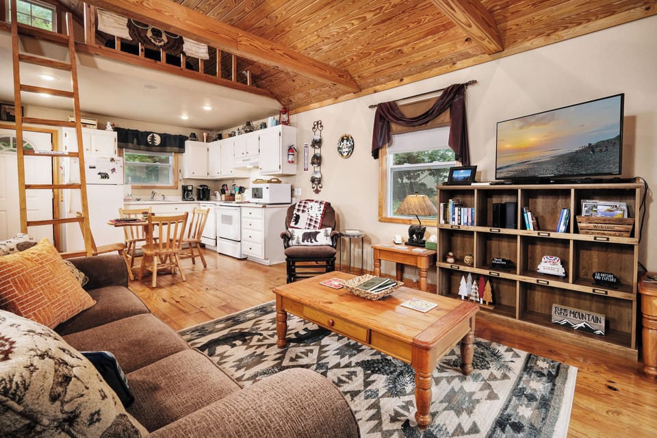 Full kitchen and living room. Loft ladder on the left.
