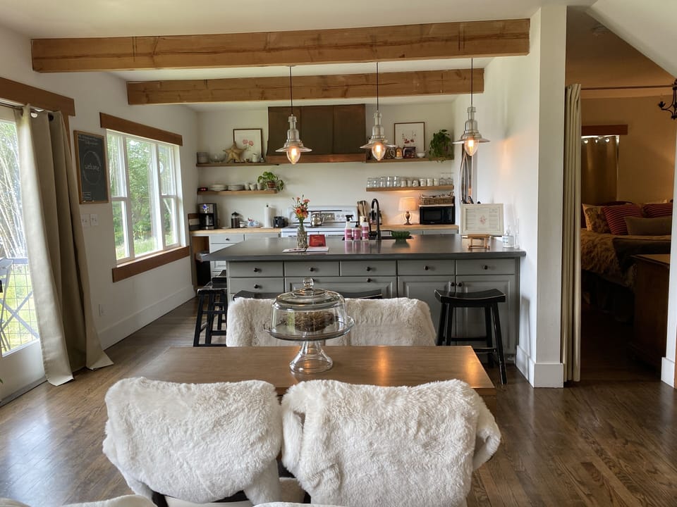 Dining area. 1st floor bedroom drape door way.